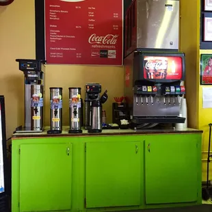 a green counter with a soda machine
