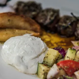 Sides of Arni Souvlaki (grilled lamb skewer). The yogurt is going so well with meats.