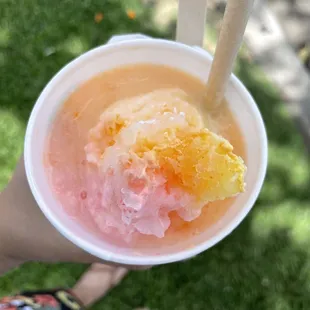 a person holding a cup of ice cream