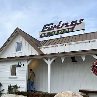 a man standing outside of a restaurant