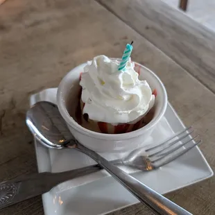 Vanilla ice cream raspberry drizzle with whipped cream. Happy birthday KA.