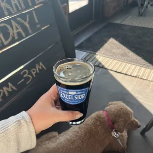 a person holding a cup of beer
