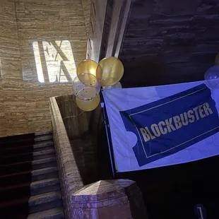 a blockbuster banner and balloons