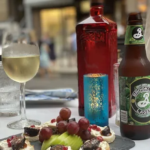 a glass of wine and a bottle of beer