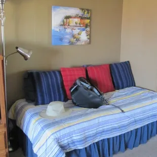 Twin bed with lots of pillows in efficiency condo