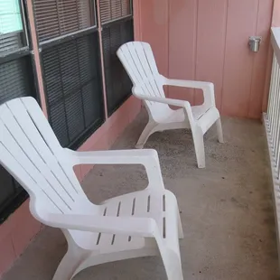 Personal patio outside our efficiency condo with two really nice chairs