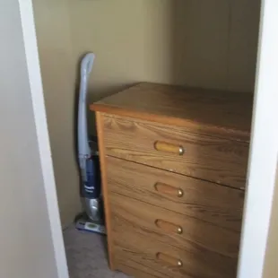 Dresser in closet and vacuum cleaner