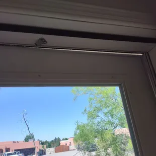 Poorly aligned screen door with absent upper air cylinder.  Also has a gap above.