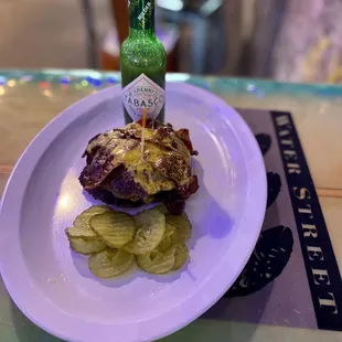 a plate of food and a bottle of sauce