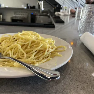 a plate of pasta and a fork