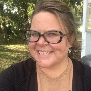 a smiling woman with glasses