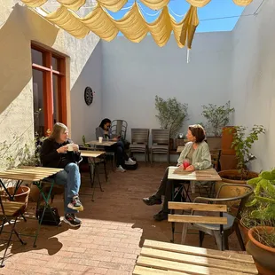 two women sitting at outdoor tables