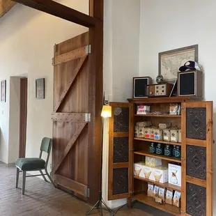 a kitchen with a wooden cabinet and a chair