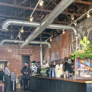 a group of people standing in a coffee shop