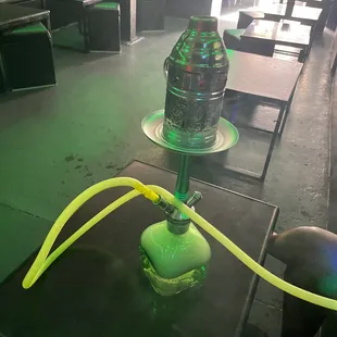 a green hookah with a yellow hose