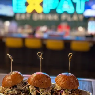 Trio Sliders: Chopped pork, brisket and shredded chicken on milk bread rolls with a side of BBQ aioli.