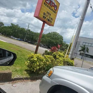 a car parked in front of a sign