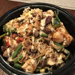 Steak, egg, shrimp, peppers, mixed veggies, green beans, and cabbage with yumyum sauce on top.