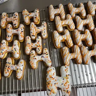 a variety of decorated donuts on a cooling rack