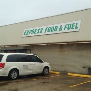 a white van parked in front of a building