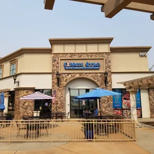 Outside, entrance to the left. Lots of outdoor seating available