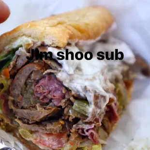 a hand holding a sandwich