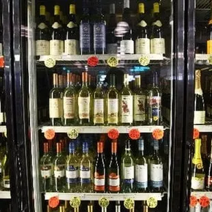 a refrigerator full of bottles of wine