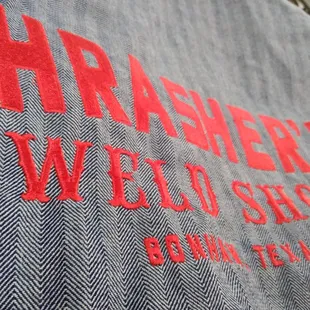 Custom Embroidery on a Full Back of Shop Coveralls for Thrasher&apos;s Weld Shop
