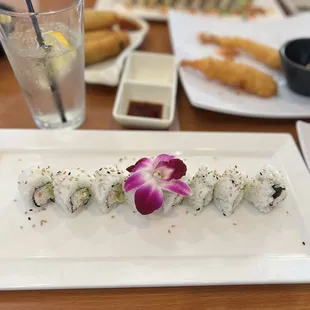 a plate of sushi and a glass of water