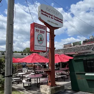 a restaurant with tables and umbrellas