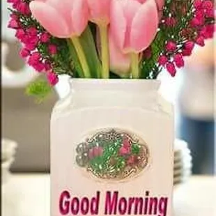 a vase with pink flowers on a table