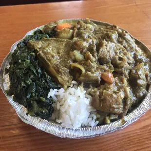 Curry goat. White rice. Spinach. Tasty, but needed some salt.
