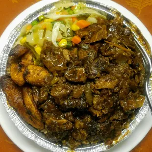 Large Dinner Platter of "Oxtail Stew with peas and rice", plaintains and sauté cabbage.
