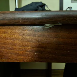 Gum under the desk right next to the bed