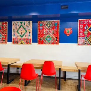 a row of red chairs in a brightly colored restaurant