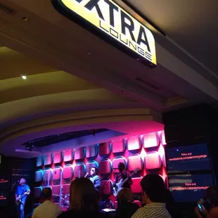 a group of people sitting at a bar