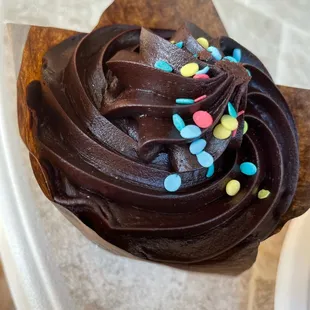 a cupcake with chocolate frosting and sprinkles