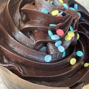 a cupcake with chocolate frosting and sprinkles