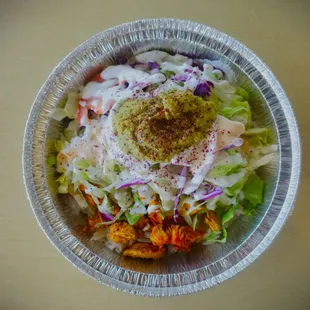 a salad in a foil container