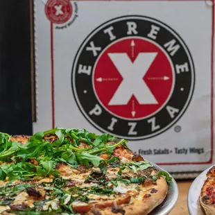 two pizzas on a table