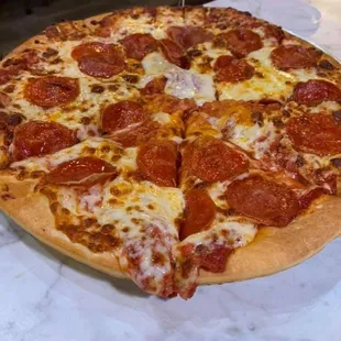 a pepperoni pizza on a table