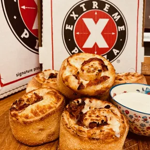 ZIPLINE KNOTS - Freshly baked dough rolled with pepperoni, hardwood-smoked bacon, mozzarella, minced garlic, oregano and olive oil.