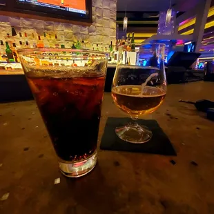 a drink and a glass on a bar