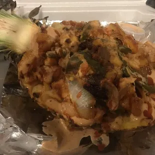 Loaded pineapple rice bowl with Chicken, served in a hollow-out 1/2 pineapple + special sauce. Flavors so great!!!  Addicting like crack!