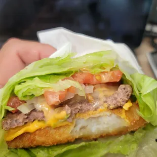 a hand holding a sandwich