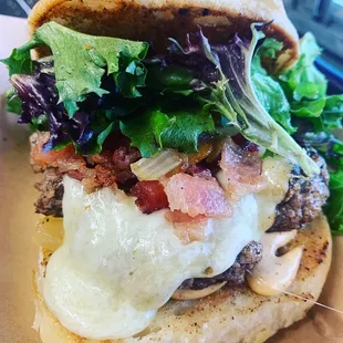 a burger with lettuce and bacon
