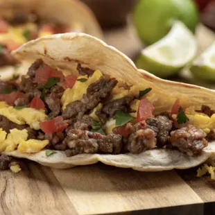 a breakfast taco on a cutting board