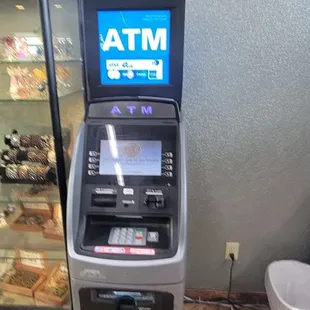 an atm machine with a cash machine in front of it