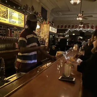 a bartender serving customers at the bar