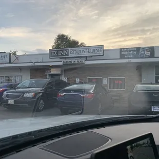 cars parked in front of a restaurant